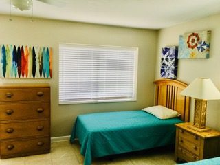 A bedroom with two beds and a dresser